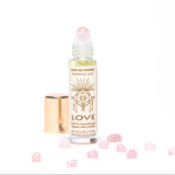 Love Essential Oil Roll On aromatherapy with rose quartz crystals.