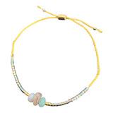 This calming + anti-anxiety bracelet holds iridescent beads and chosen stones on an adjustable gold thread.