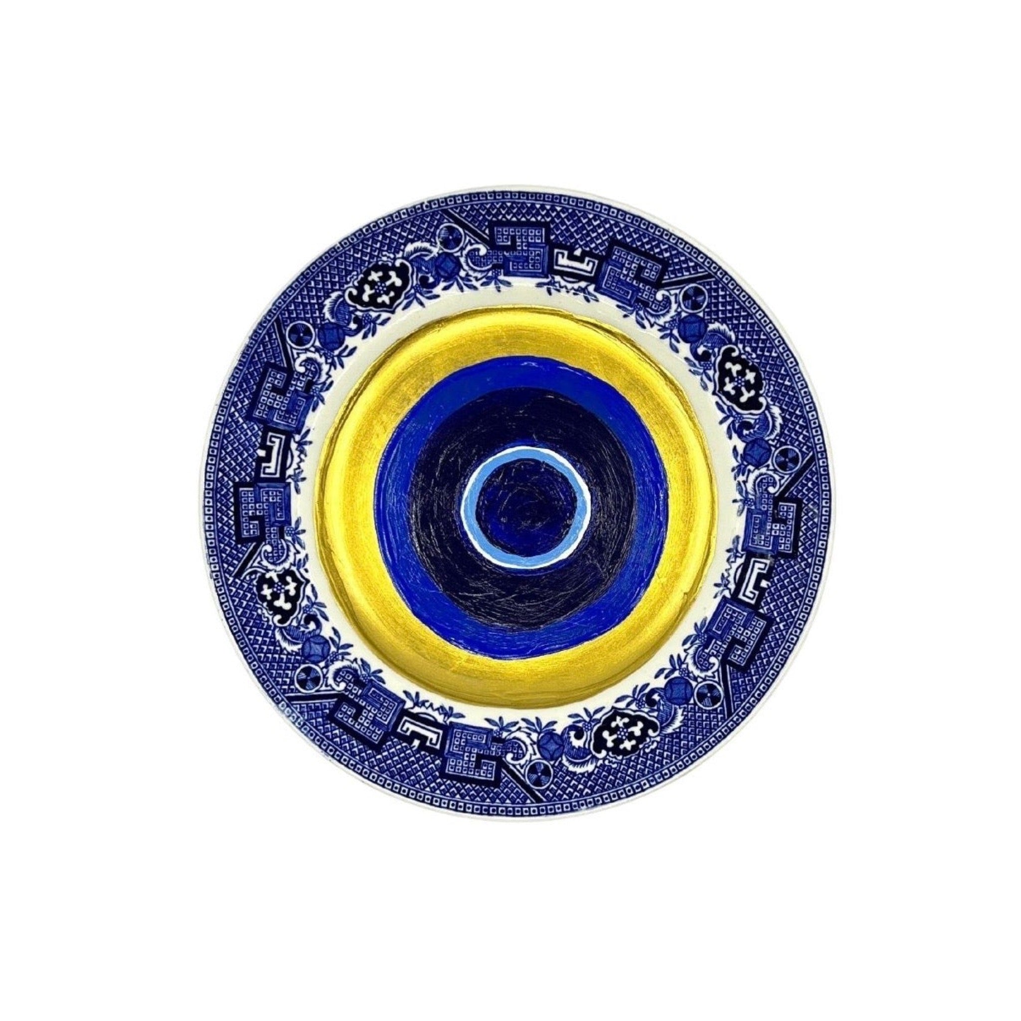 Antique vintage blue plates have been given new life with hand-painted evil eyes. Just the thing we need that we didn't even know we needed.