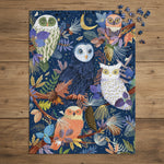 Jigsaw puzzle with colorful owl design on a blue background on a rustic wood tabletop