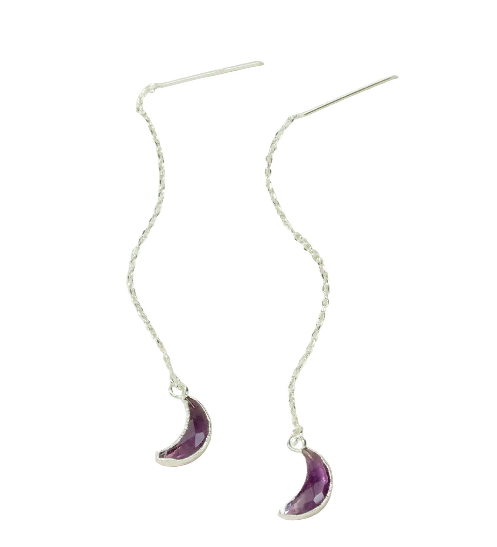 Silver earrings with purple crescent moon charms on a light background