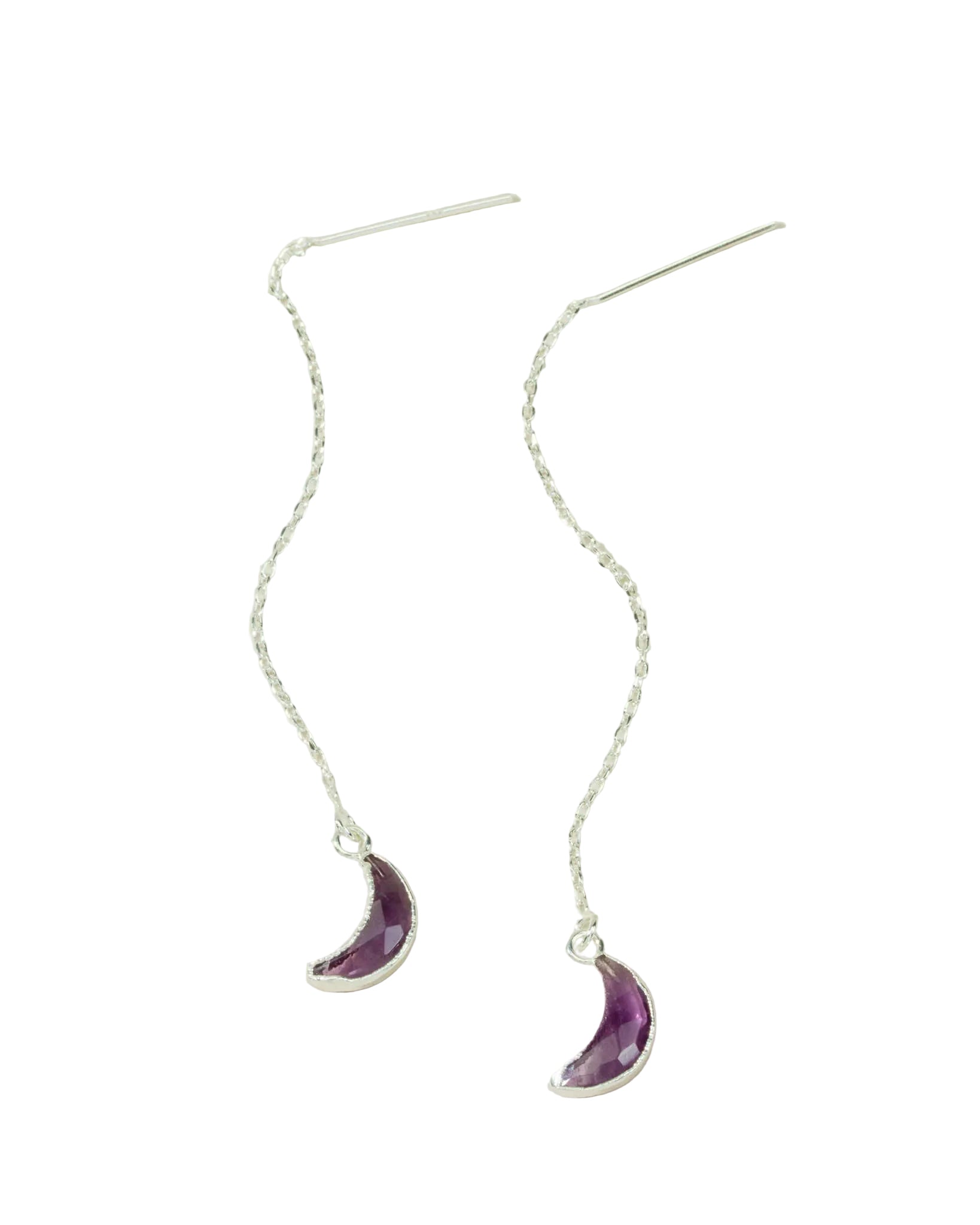 Silver earrings with purple crescent moon charms on a light background