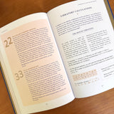 Open book with Numeric Vibratory calculations on a wood surface