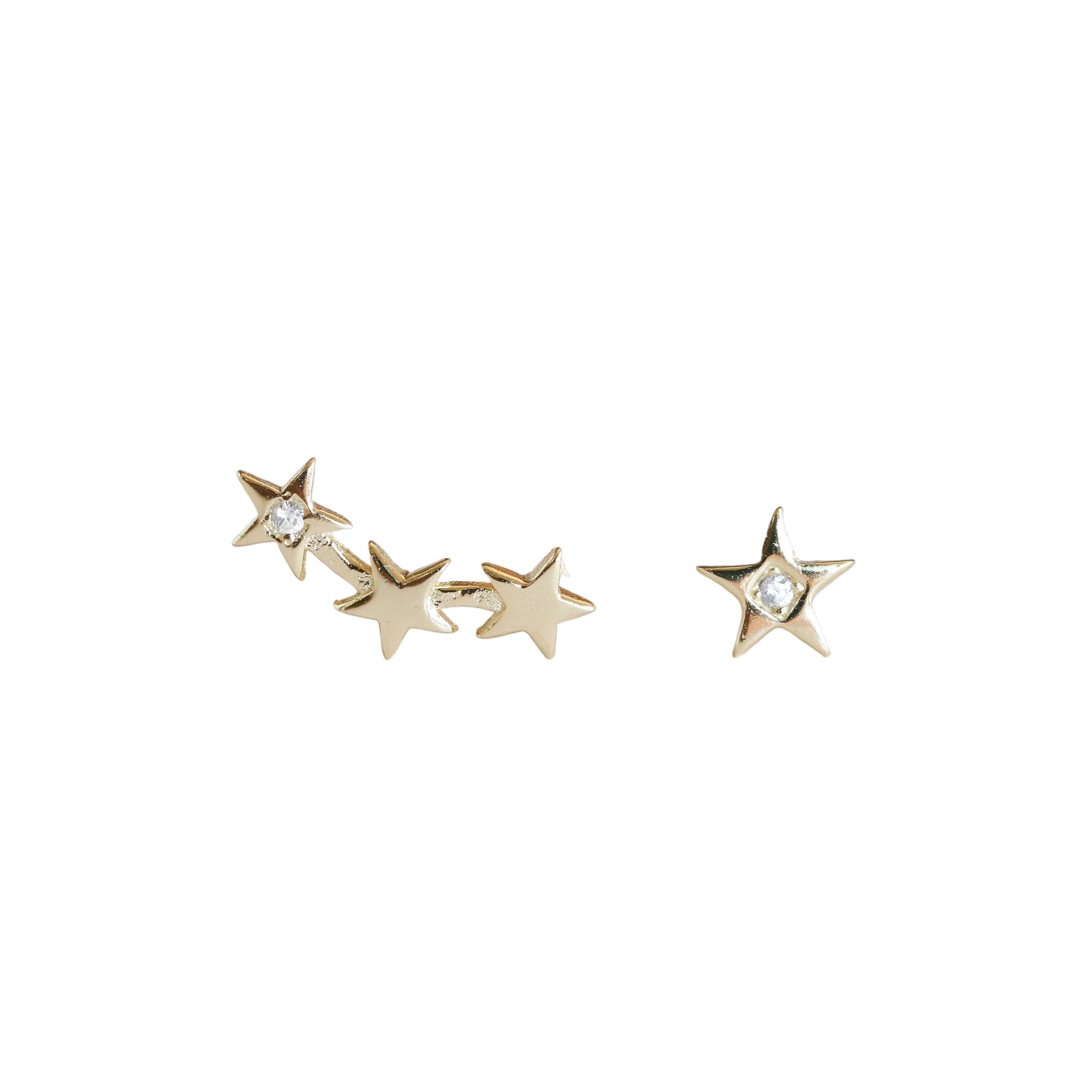 Gold star-shaped earrings on a light gray background