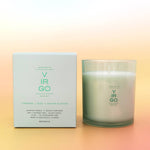 Candle and packaging with 'Virgo' branding on a gradient background