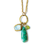 Necklace with gold chain, green and blue stone pendants on a white background