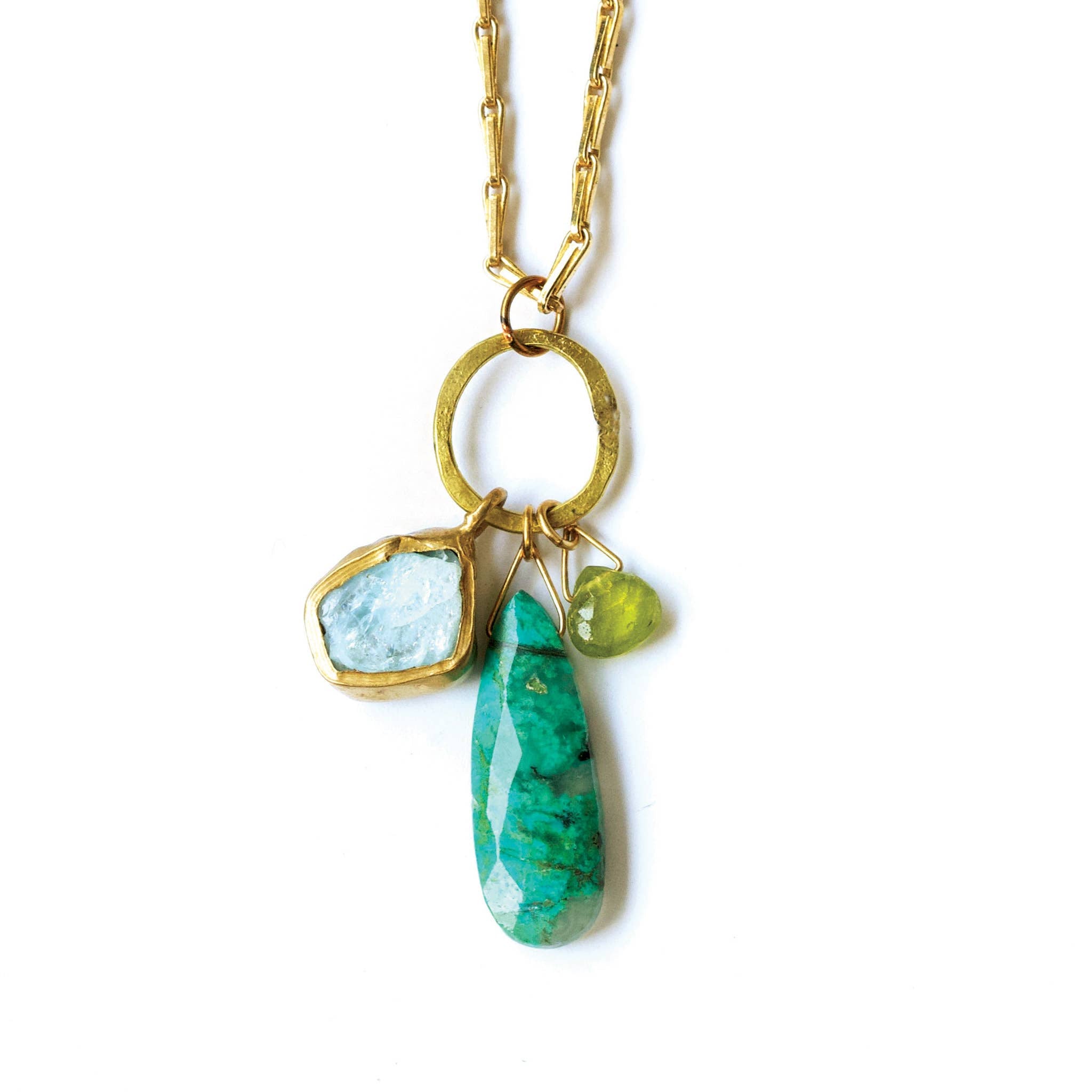 Necklace with gold chain, green and blue stone pendants on a white background