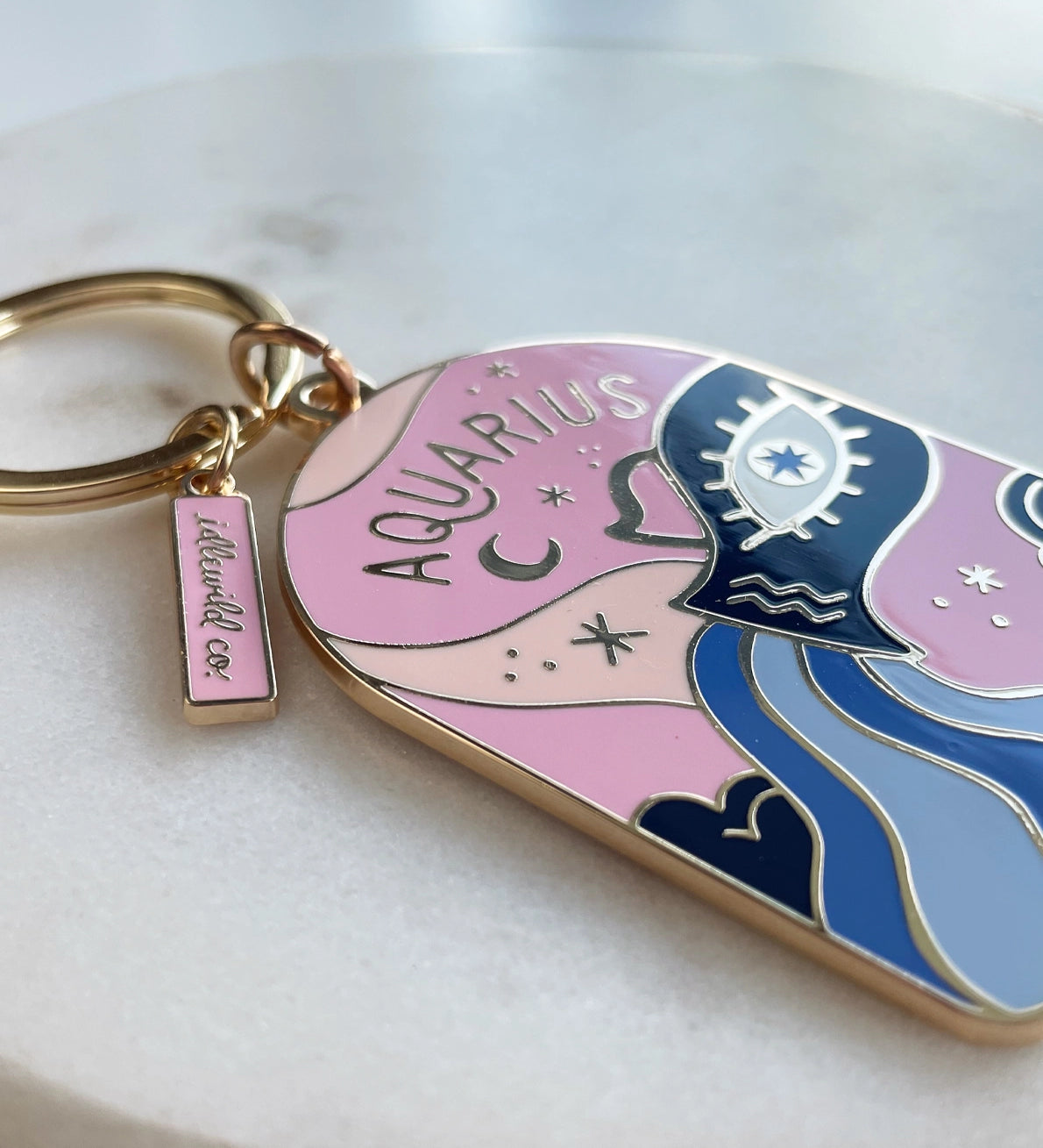 Keychain with Aquarius design on a light background