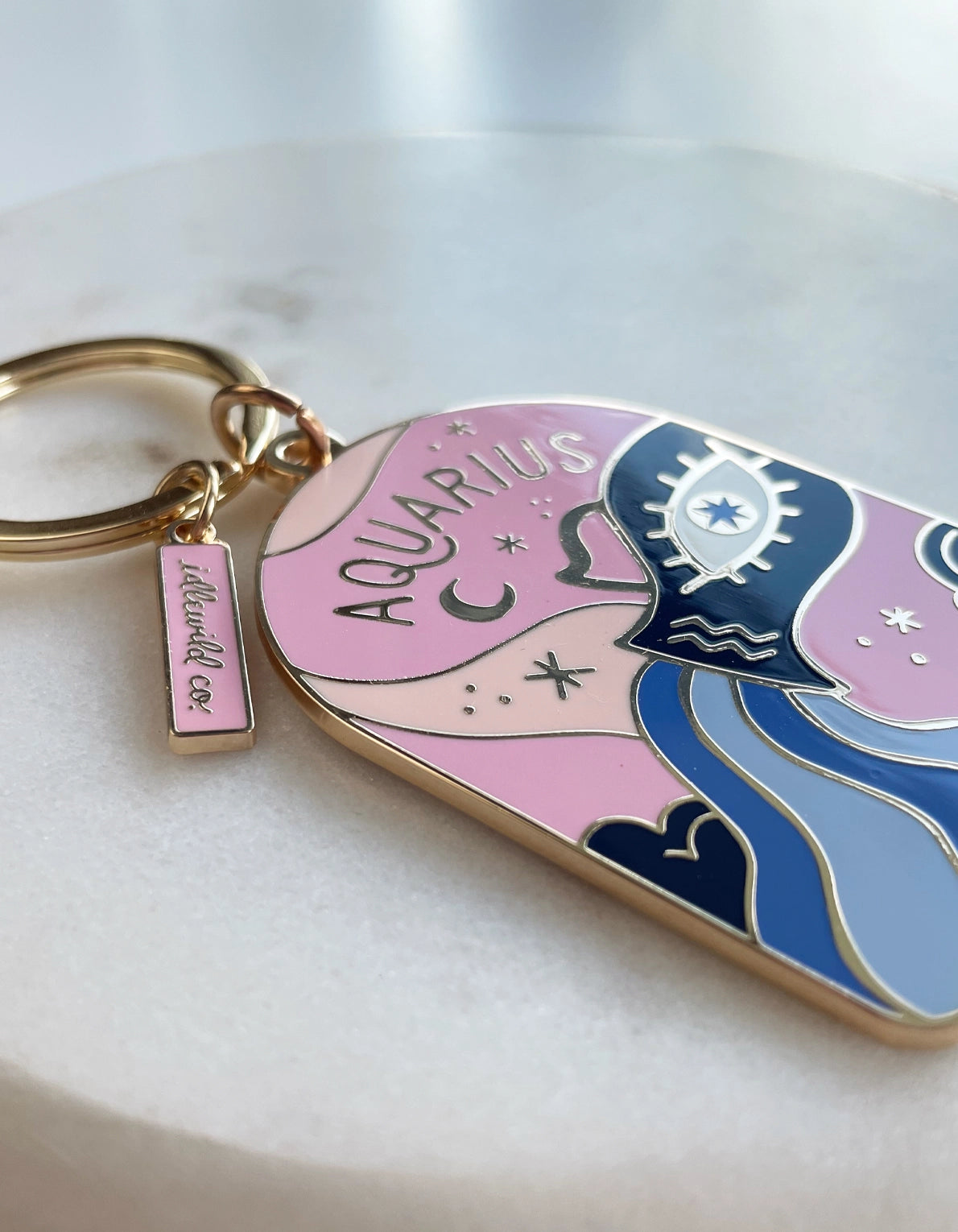 Keychain with Aquarius design on a light background