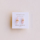 Jax Kelley rose quartz earrings on a branded card against a light background