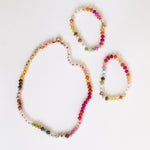 Set of colorful beaded necklaces on a white background
