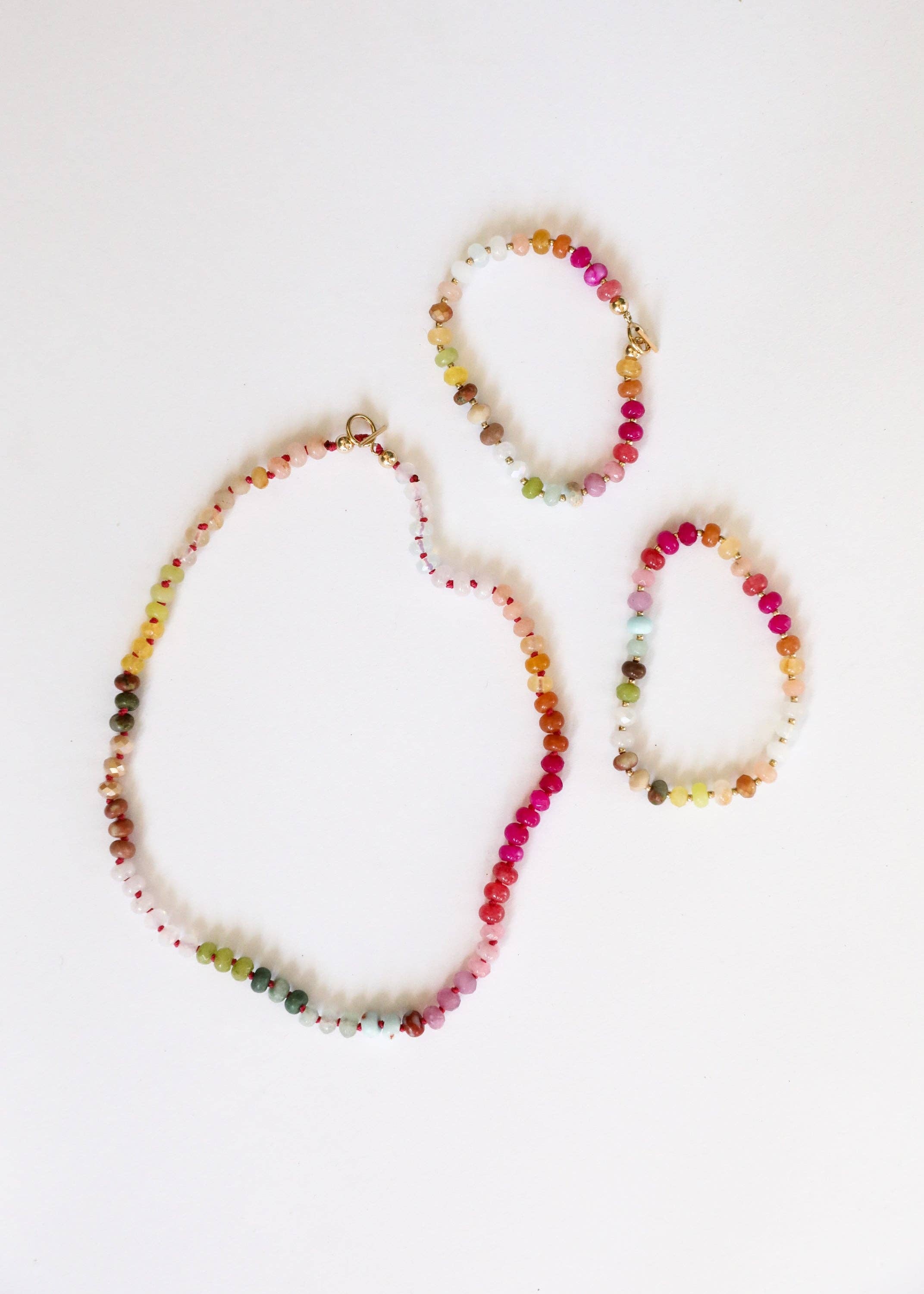 Set of colorful beaded necklaces on a white background