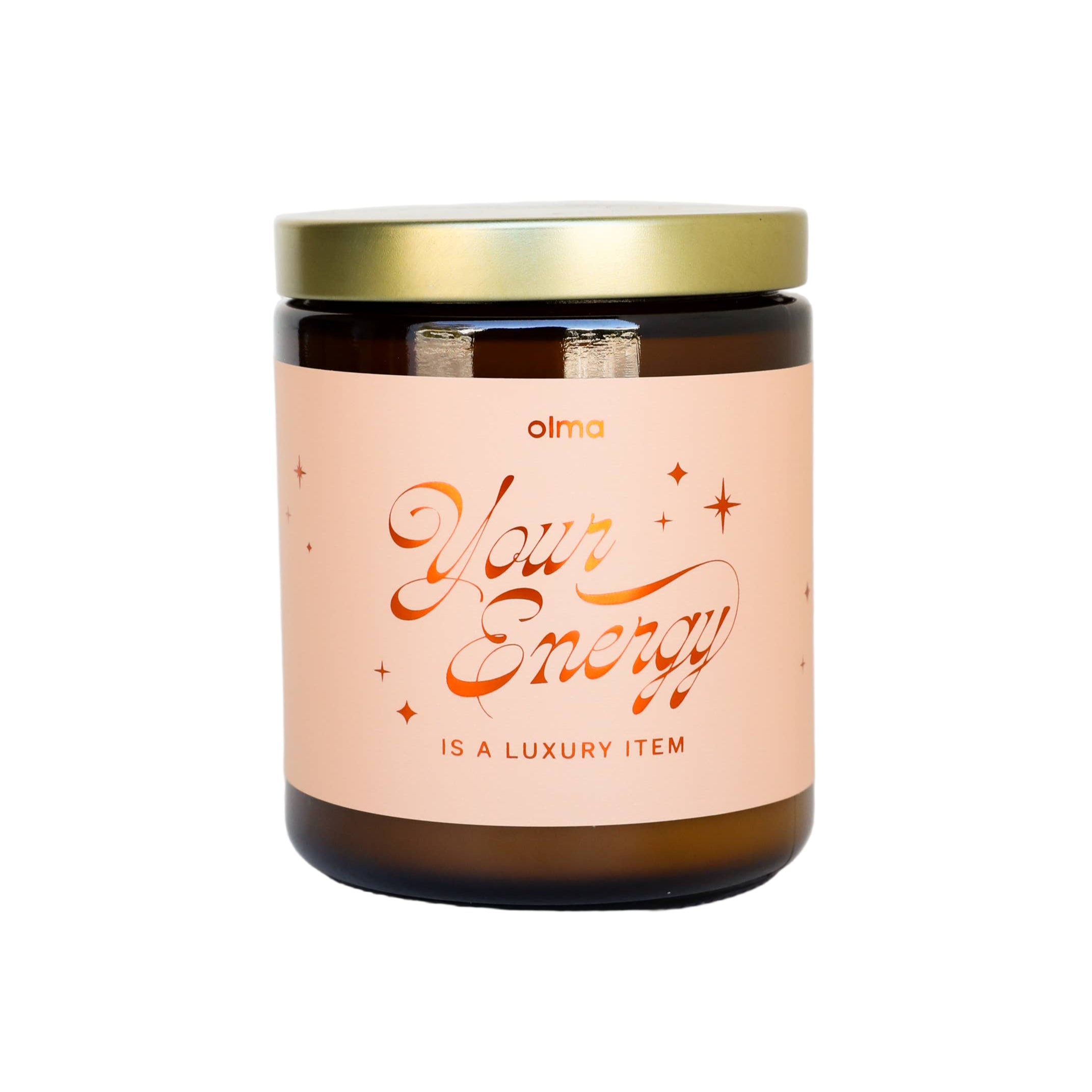 Candle with a gold lid and pink label on a white background