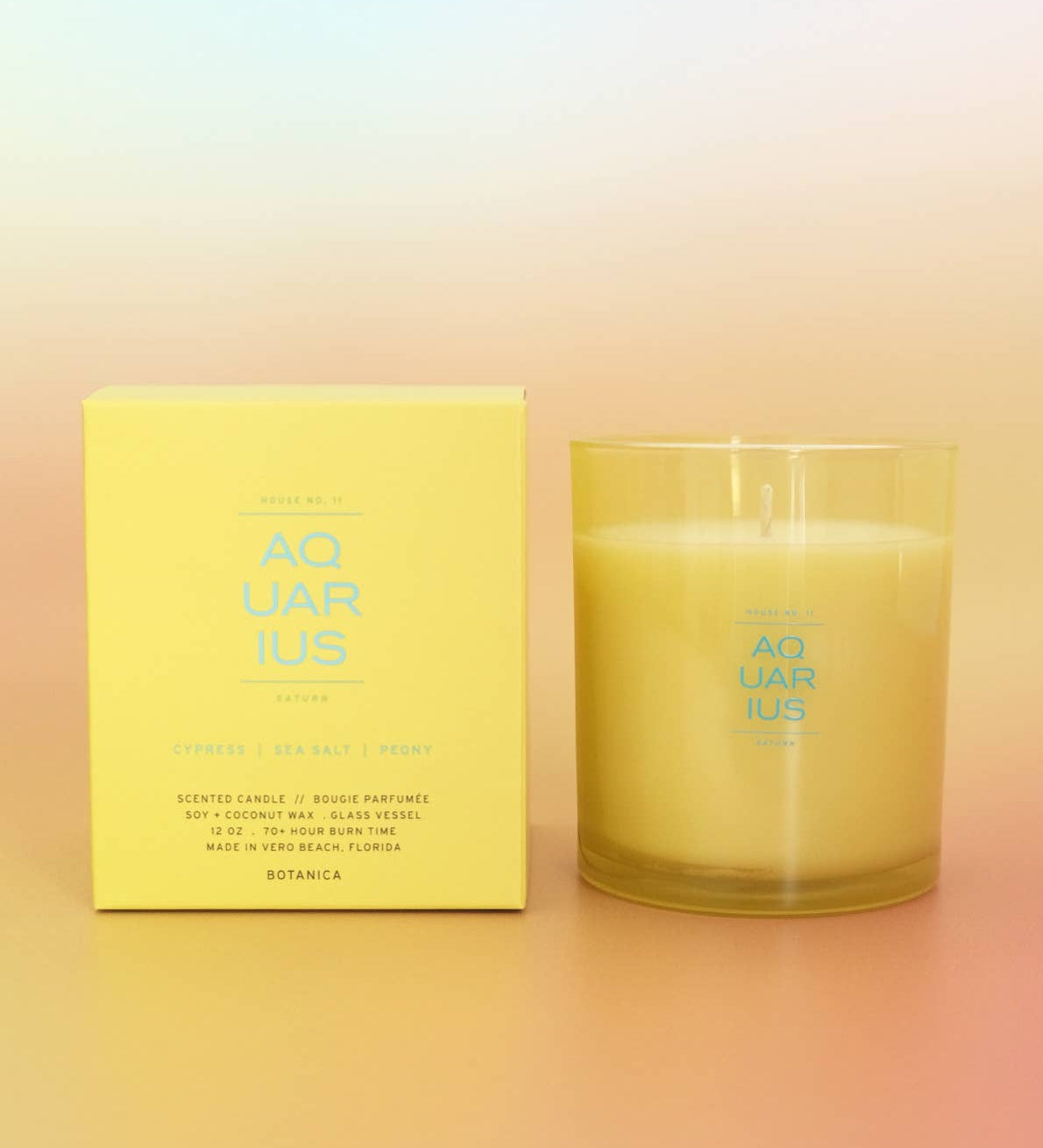 Candle and its packaging with 'Aquarius' branding on a gradient background