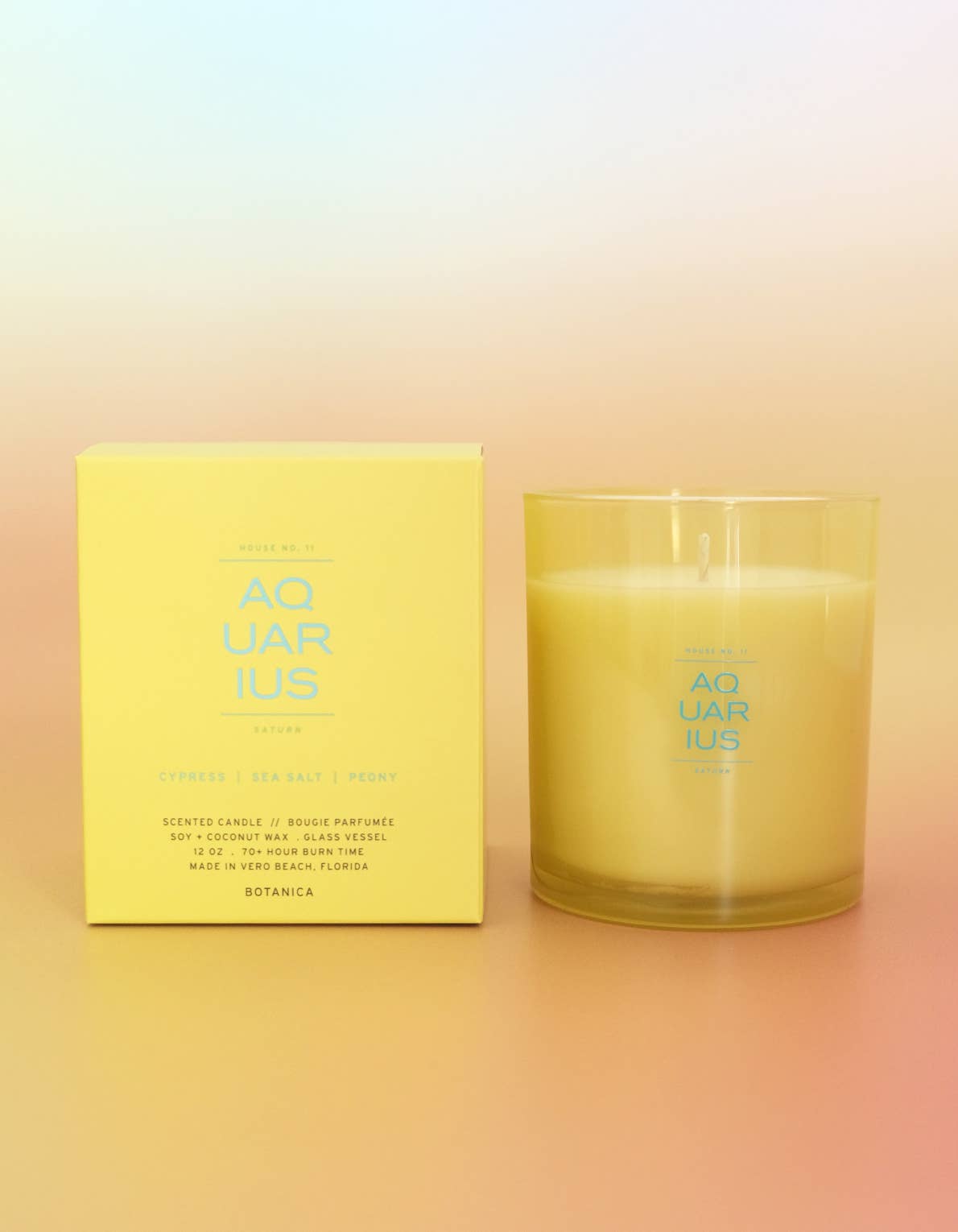 Candle and its packaging with 'Aquarius' branding on a gradient background
