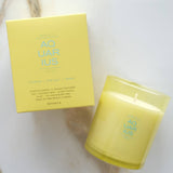 Yellow candle and packaging labeled 'Aquarius' on a marble surface