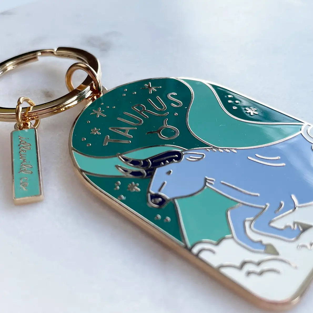 Light blue bull on a green background on a keychain