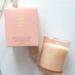 Candle and packaging with 'GEMINI' branding on a marble surface