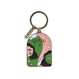 Colorful enamel and brass keychain with GEMINI and two faces on a white background