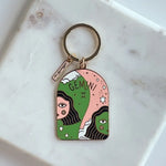 Keychain with Gemini zodiac design on a marble surface