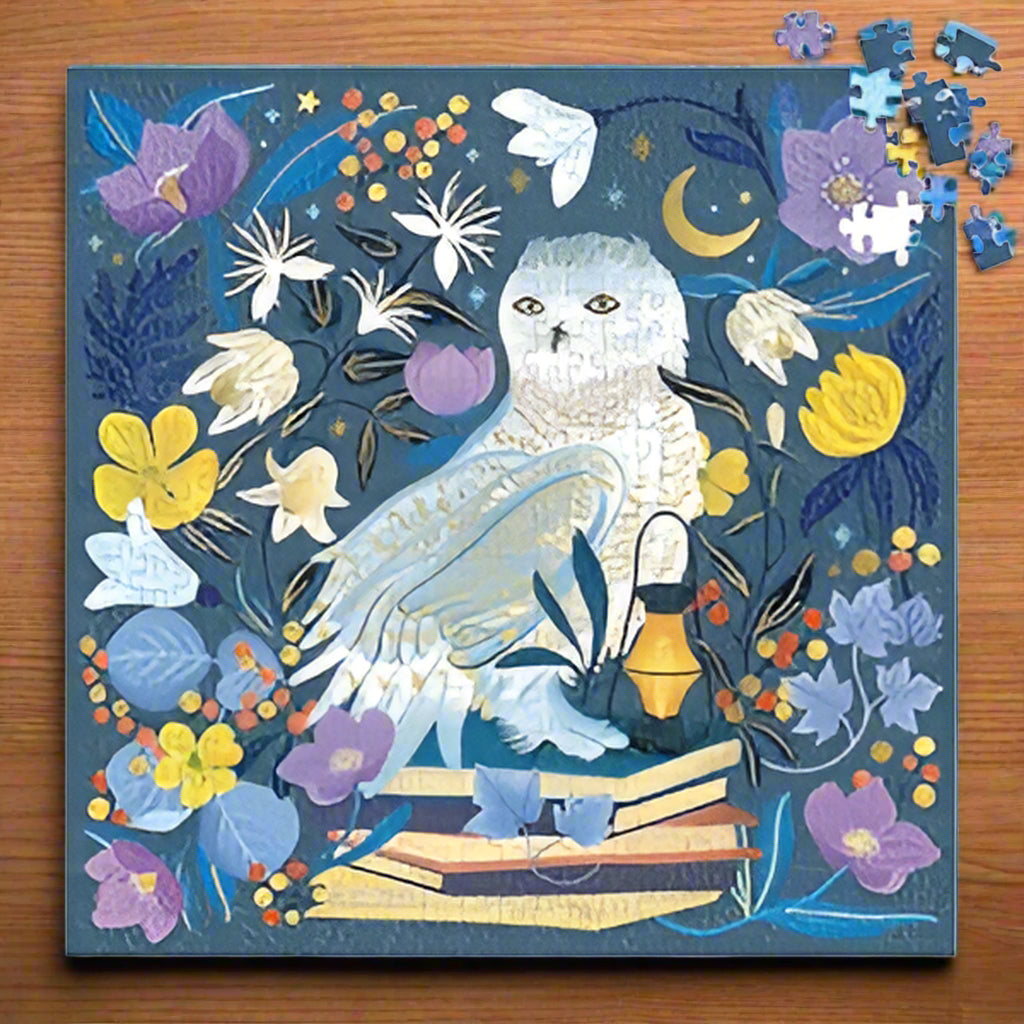 Jigsaw puzzle with a snowy owl and floral design on a blue background
