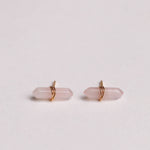 Pair of pink crystal earrings on a light gray background