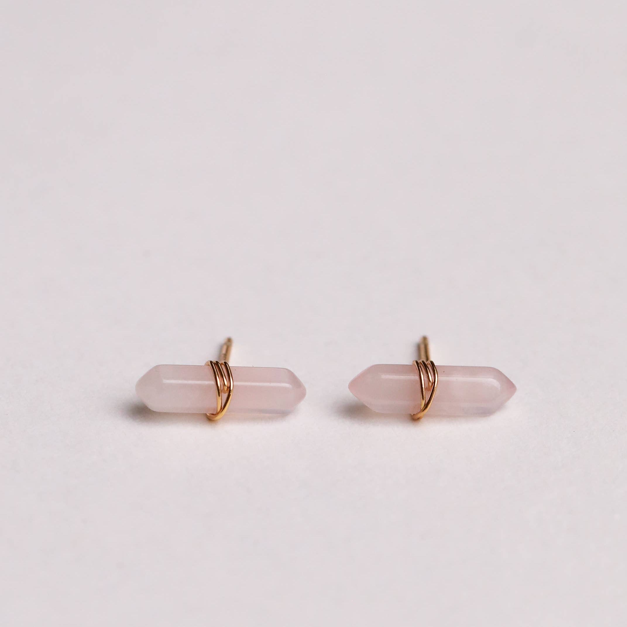 Pair of pink crystal earrings on a light gray background