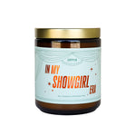 Candle jar with a label reading 'In My Showgirl Era' on a white background