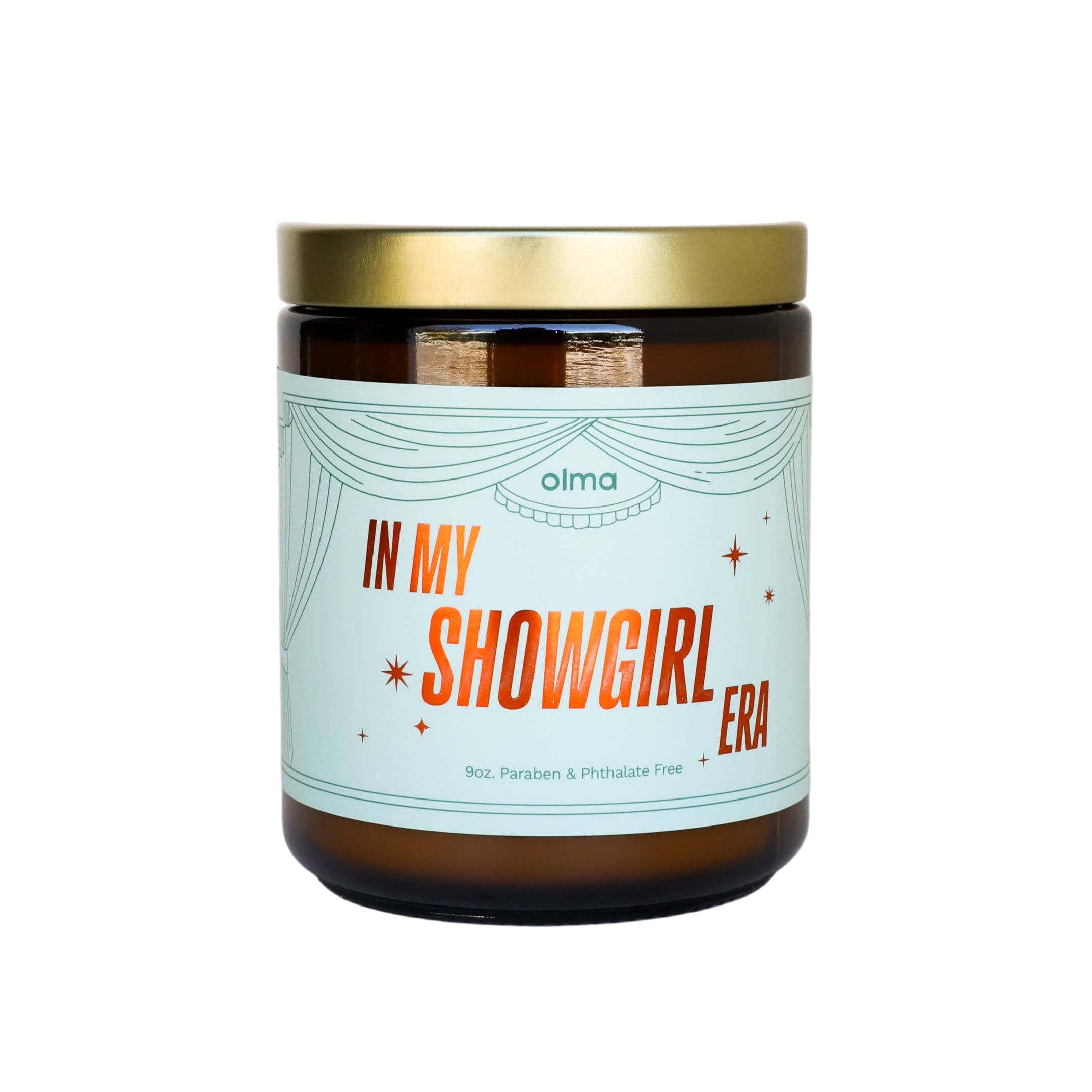 Candle jar with a label reading 'In My Showgirl Era' on a white background