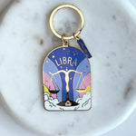 Keychain with Libra zodiac design on a marble surface
