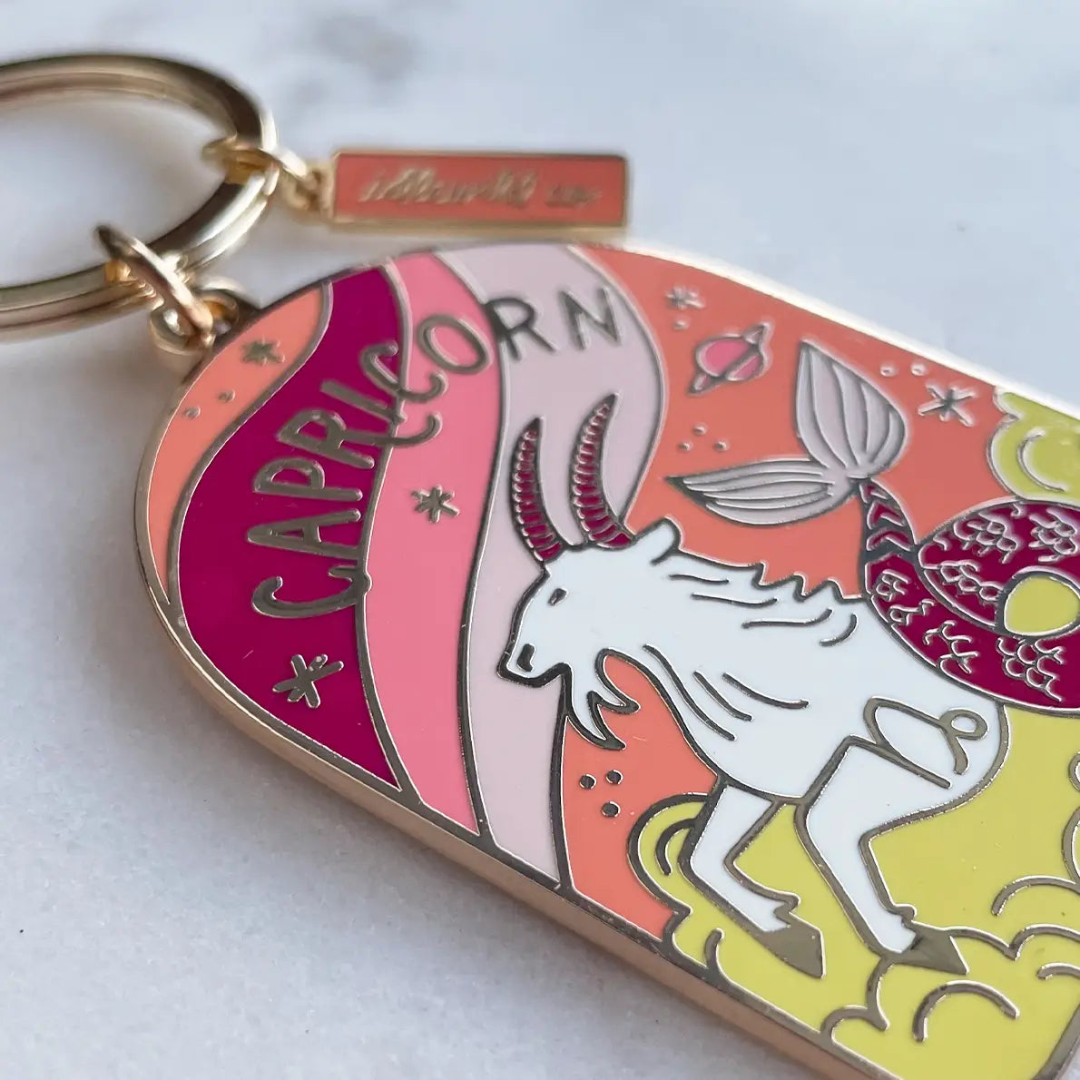 Capricorn zodiac keychain with colorful design on a white background
