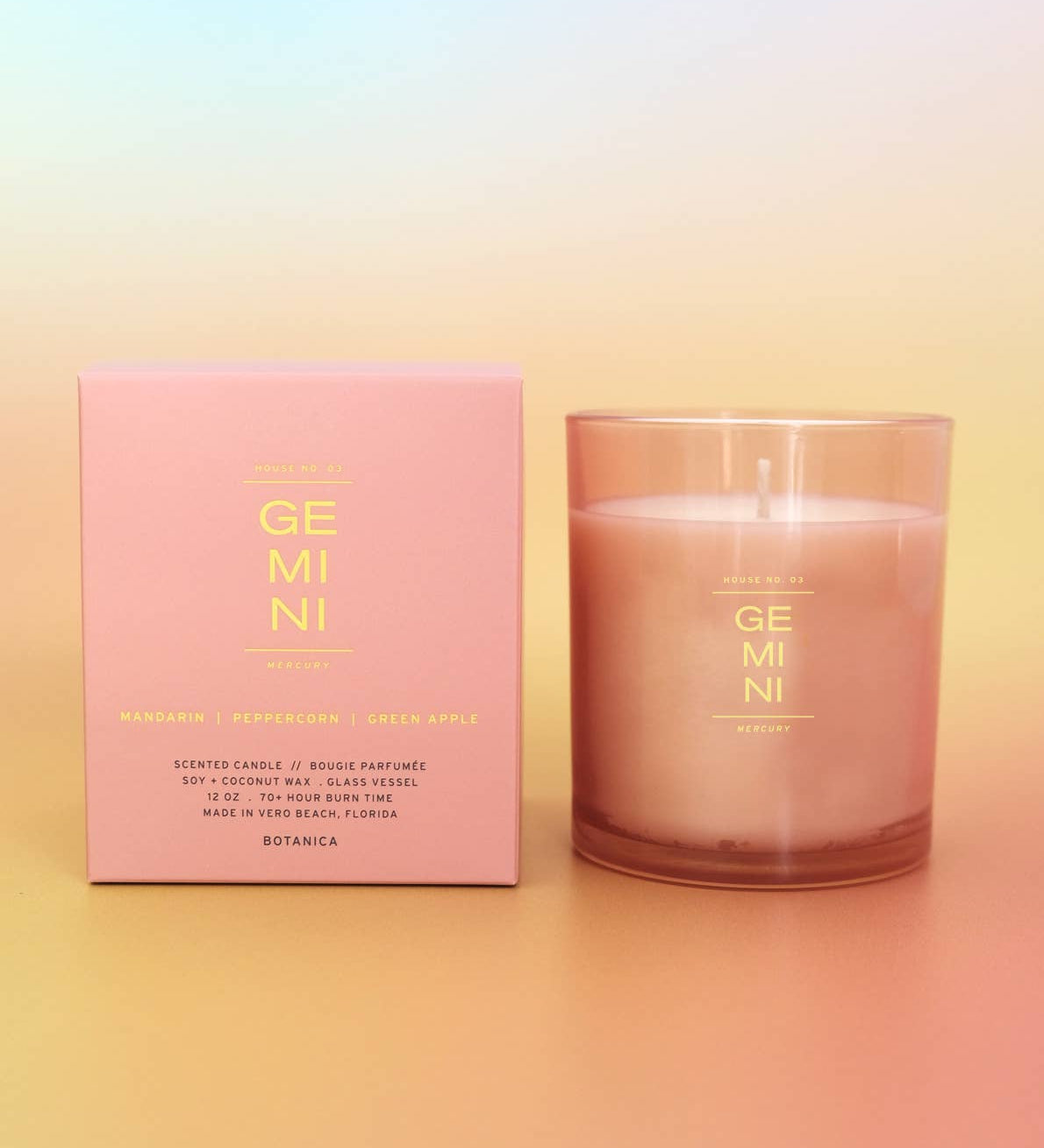 Candle and packaging with 'GEMINI' branding on a gradient background