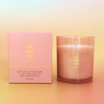 Candle and packaging with 'GEMINI' branding on a gradient background