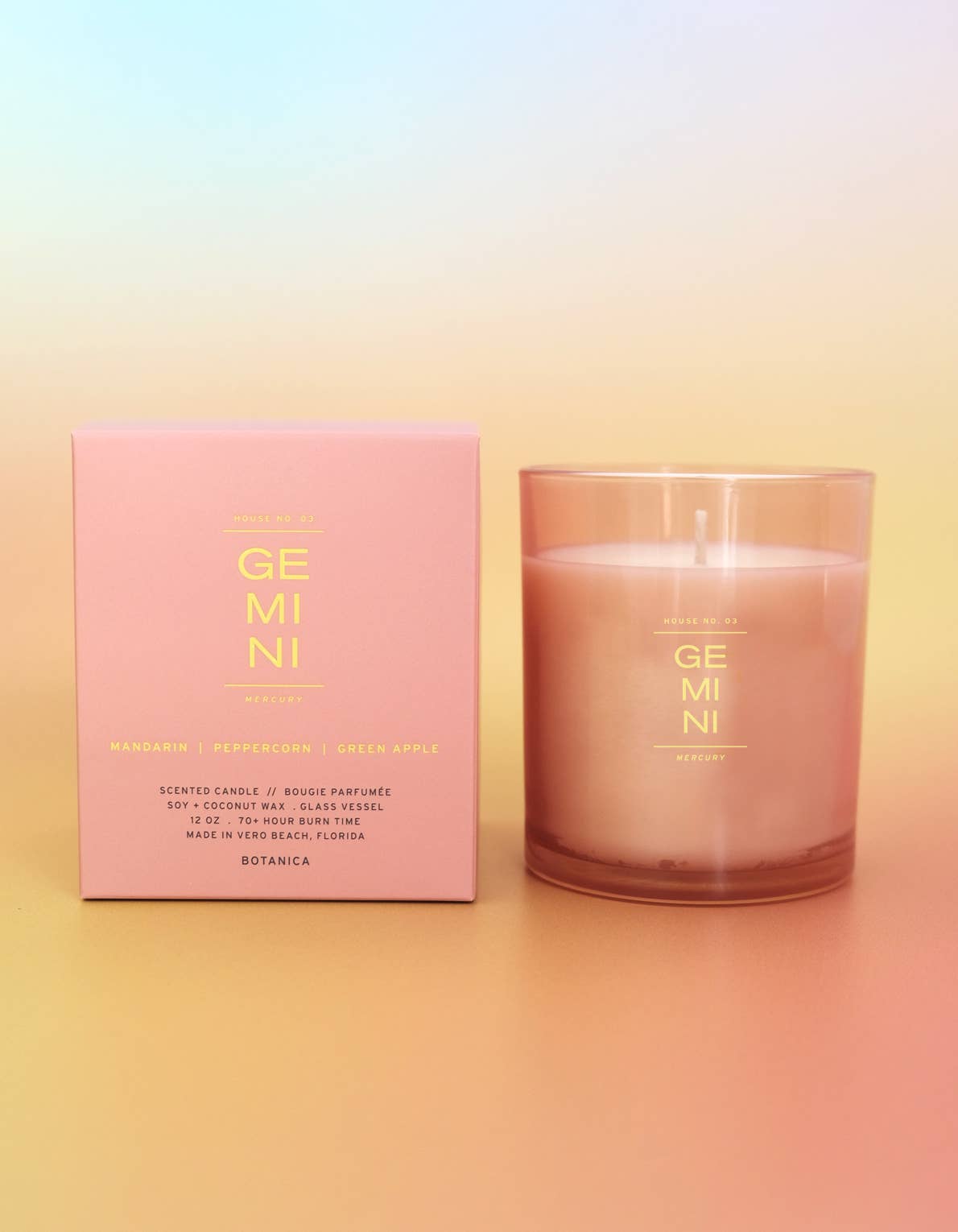 Candle and packaging with 'GEMINI' branding on a gradient background