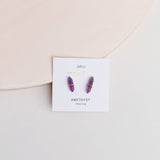 Amethyst earrings on a branded card with a soft background