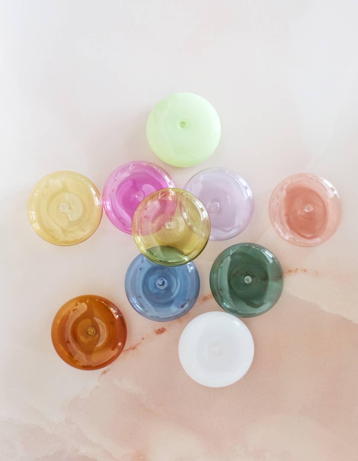 Assorted colored bottle caps on a light background