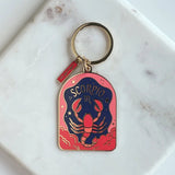 Scorpio zodiac keychain on a marble surface