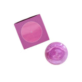 Pink bubble shaped glass incense holder and pink box on a white background