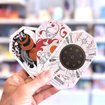 Hand holding three tarot cards with intricate designs against a blurred background