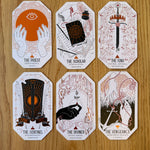 Set of six stylized playing cards on a wooden surface