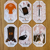 Set of six stylized playing cards on a wooden surface
