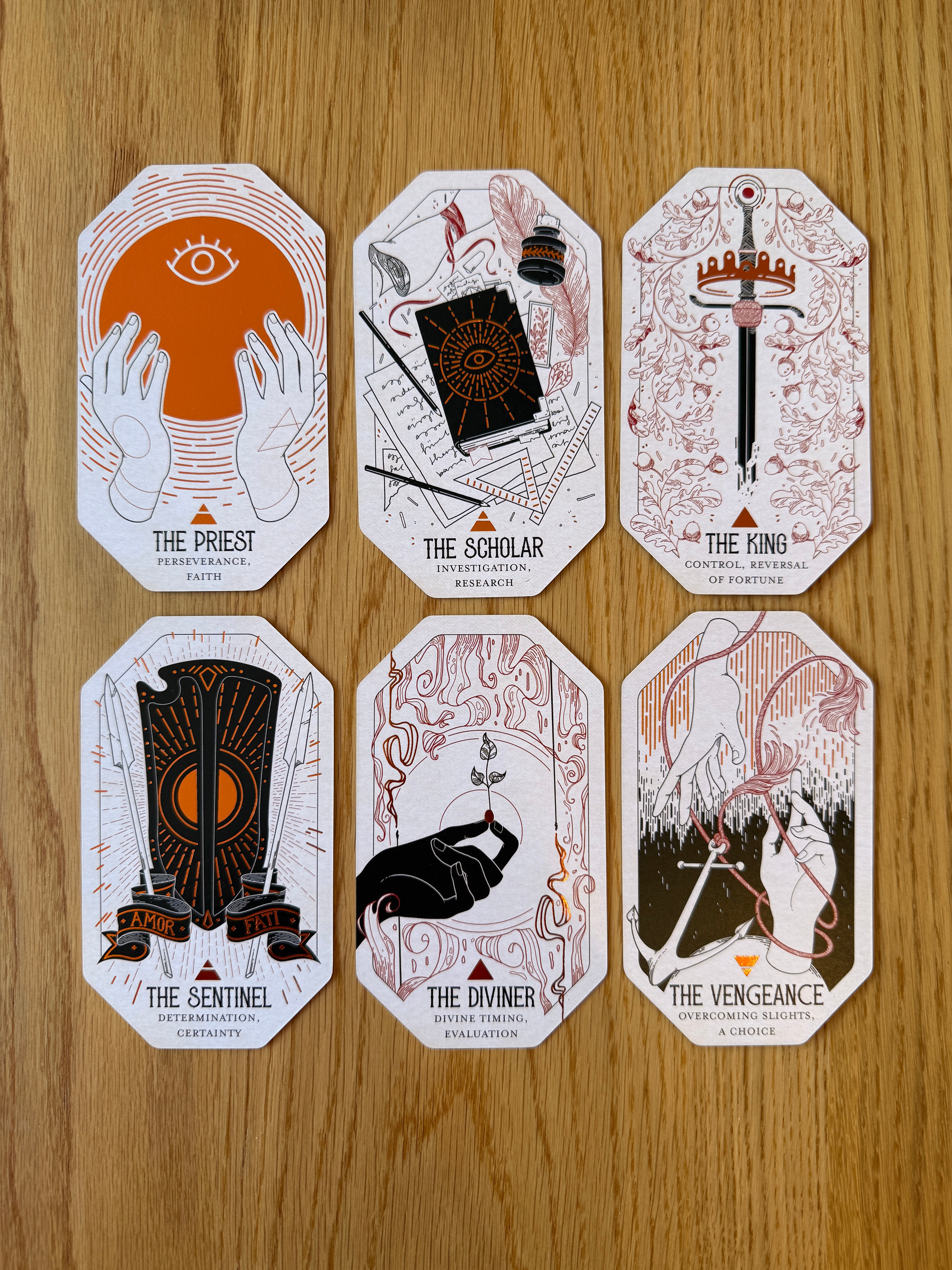 Set of six stylized playing cards on a wooden surface