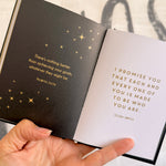 Open book with inspirational quotes on black and white pages