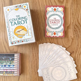 Coloring Tarot cards with packaging on a wooden surface