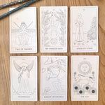 Set of tarot cards on a wooden surface with a pencil.