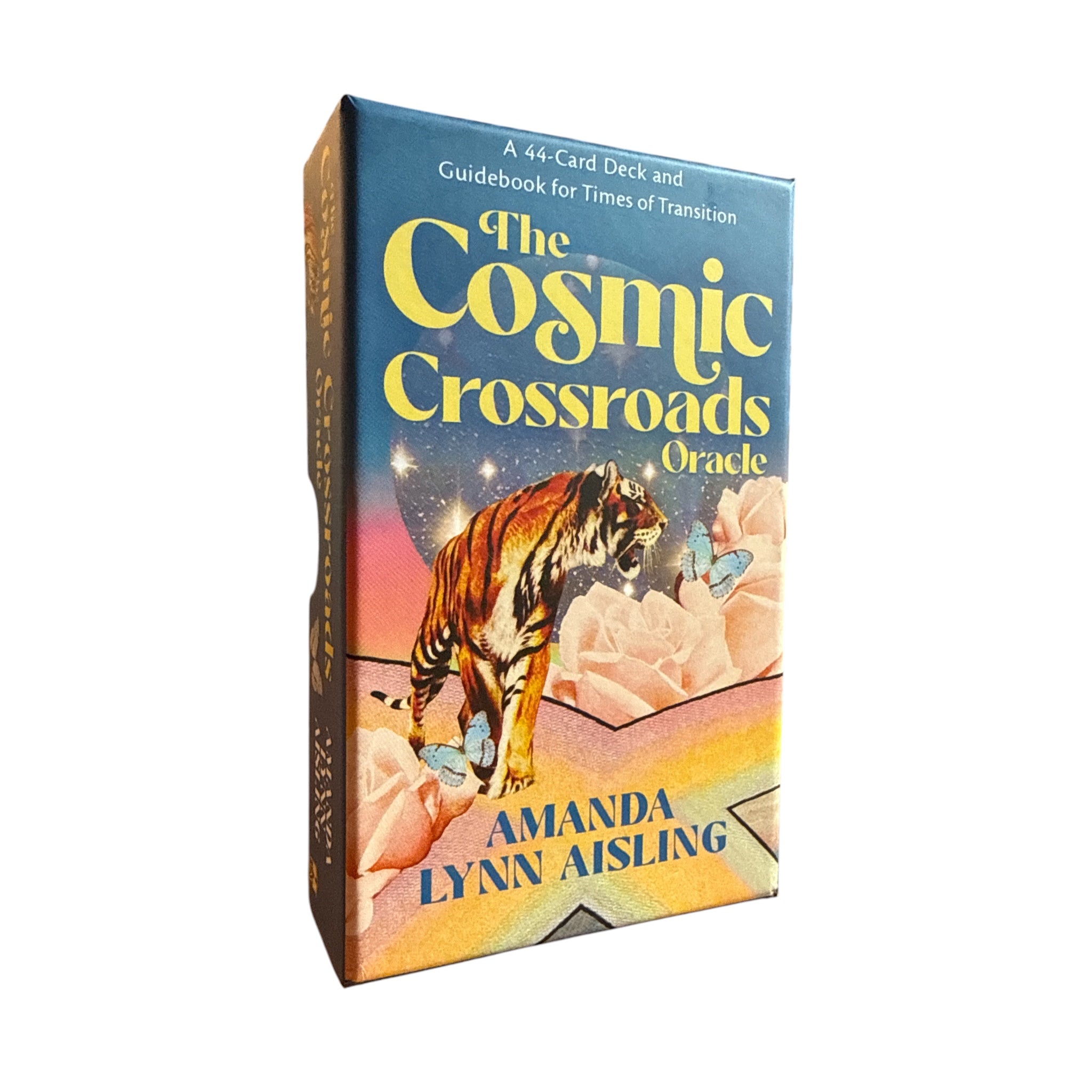 The Cosmic Crossroads Oracle card deck box by Amanda Lynn Aisling, featuring a blue and yellow cover with an illustration of a tiger among pink roses.