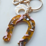 Keychain with floral design and 'Certified Lucky' text on a white background