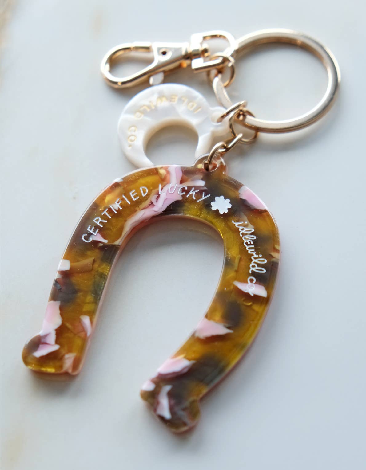 Keychain with floral design and 'Certified Lucky' text on a white background