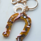 Keychain with floral design and 'Certified Lucky' text on a white background