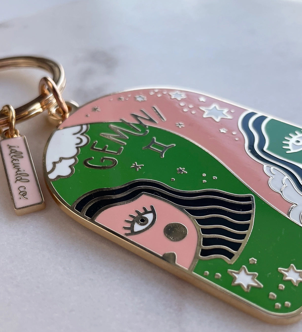Keychain with Gemini zodiac design on a white background